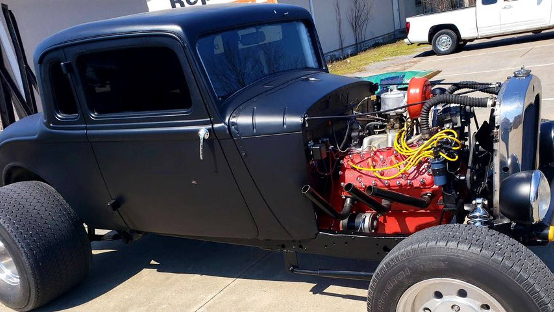 Black hot rod with exposed red engine