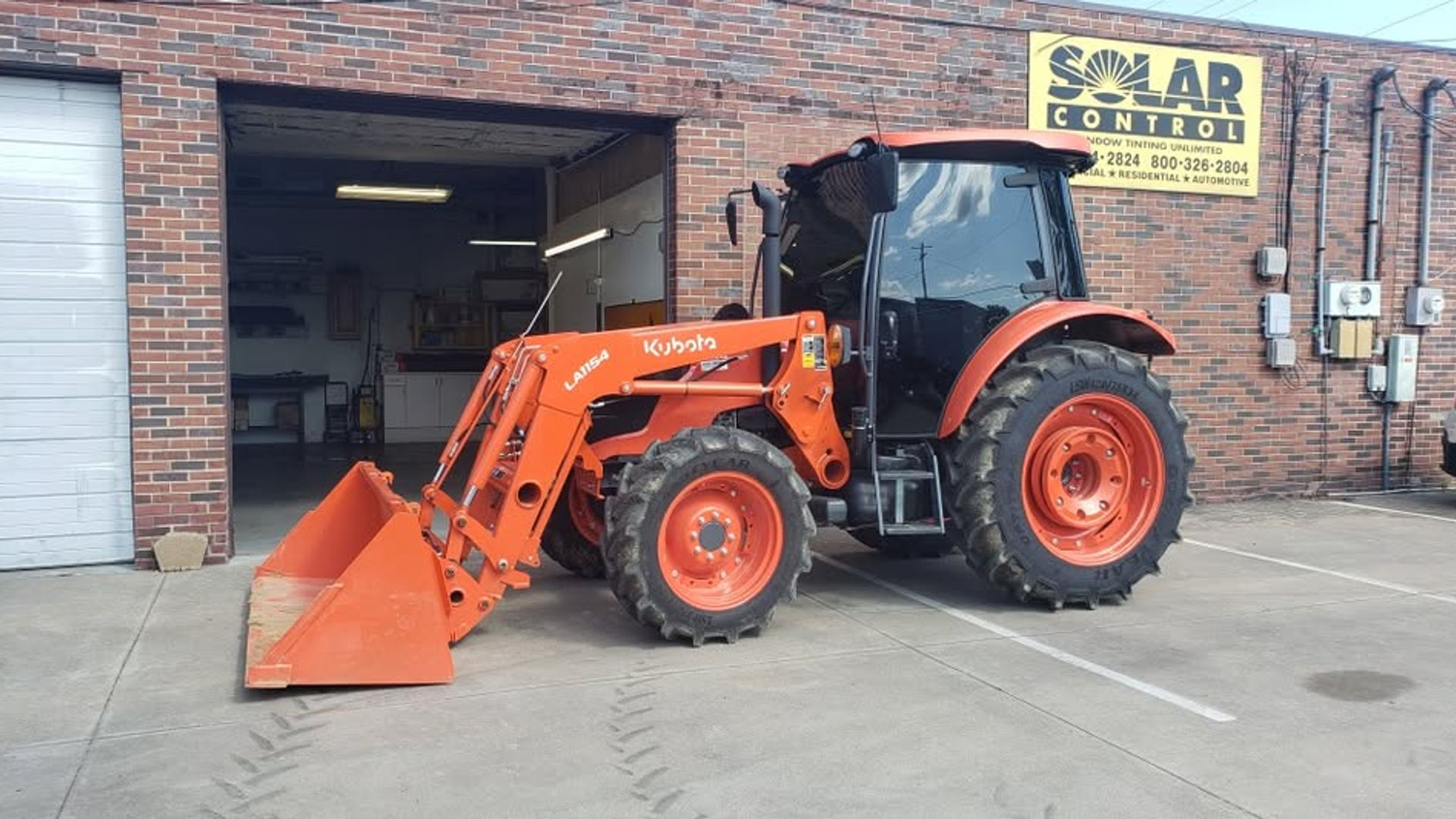 Kubota tractor with tinted cab at the shop