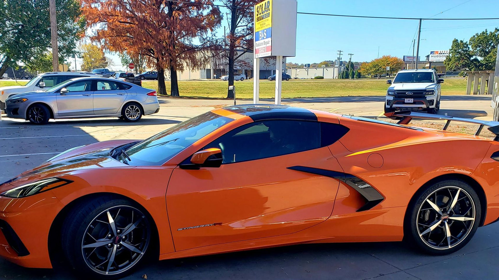 Orange C8 Corvette with tinted windows
